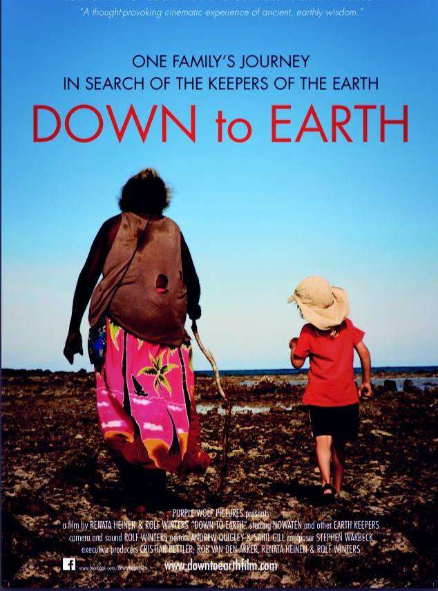 down to earth documentary poster - a woman and a child are walking away over a barren field